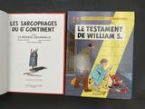 two books on a table with a black background and a black background