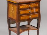 an image of a small wooden table with drawers and a shelf
