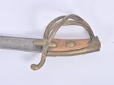 an old sword with a wooden handle on a white surface