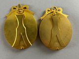 a pair of gold plated earrings with a lady ' s silhouette on them