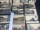 several old black and white photographs of people and buildings on a table