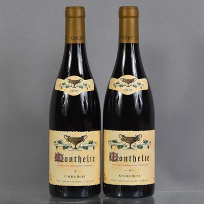 two bottles of wine sitting next to each other on a table