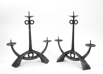 pair of iron candlesticks in the shape of an eye