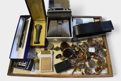 a wooden box filled with assorted items on a white surface