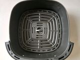 an image of a black frying pan on a white surface