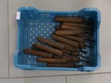 a lot of cigars in a blue basket on the floor