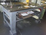 an image of a workbench in a factory with a lot of work on it