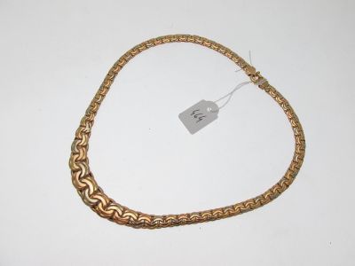 une photo d'un bracelet en chaîne dorée muni d'une étiquette