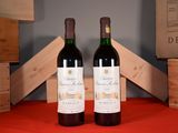 two bottles of wine sitting next to each other on a table
