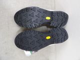 pair of black and yellow shoes on a couch with a white background
