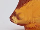 a close up of a glass fish on a white surface