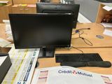 a desk with a computer, keyboard, mouse, and papers on it