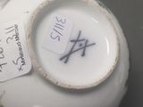 a close up of a tea pot with a tag on it