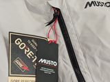 the jacket is white and black and has a tag on it
