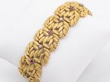 a close up of a gold bracelet on a white napkin