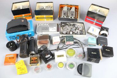 many different types of cameras and accessories laid out on a table