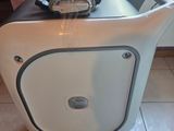 a white cart with a black handle and a cell phone on it