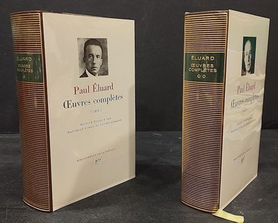 two books on a table with a picture of a man in a suit