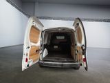 a white van with its doors open in a room
