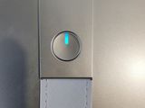 a close up of a metal object with a blue light on it