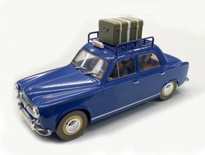 a blue toy car with luggage on top of it