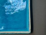 a blue plate with a white cloud in it