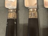 three knives that are sitting next to each other on a table