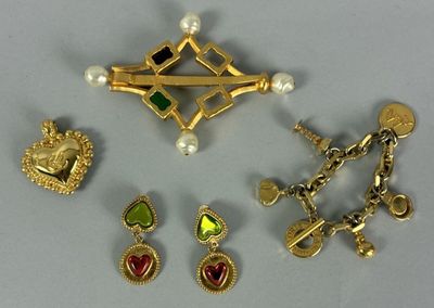 several different types of jewelry including a brooch, earrings, and a cross