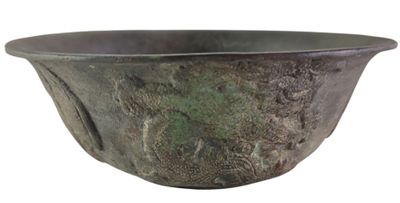 a metal bowl that is sitting on a white surface