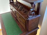 a wooden table with a green mat on it