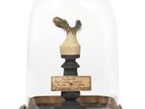 an image of a statue of a bird under a glass dome