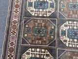 a rug on the floor with a cat sitting on top of it