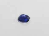 a close up of a blue sapphire stone on a white surface