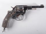 an old gun with a wooden handle on a white surface