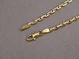 a close up of two gold chains with diamonds on them
