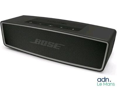 a close up of a black speaker on a white surface