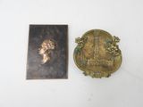 a close up of a metal plaque with a picture of a woman on it