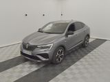 a grey car parked in a garage with a checkered floor