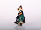 a figurine of a man sitting on a chair