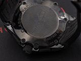 a close up of a watch on a black surface