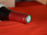 a bottle of wine on a table with a red cloth