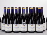 six bottles of wine are lined up in a row on a table