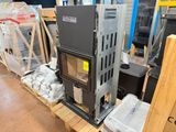 a stove sitting on a pallet in a warehouse