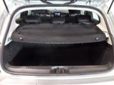 the back of a car with its trunk open and the seats folded down