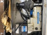 a box that has a drill and other tools inside of it