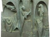 une statue représentant un homme tenant un bâton et une femme tenant une épée