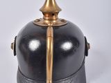 a black and gold helmet with a gold top on a white background