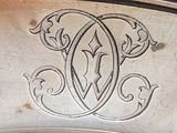 a silver plate with a monogram on it