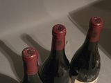 three bottles of wine sitting on a counter next to each other