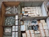 a box full of assorted metal items on the floor